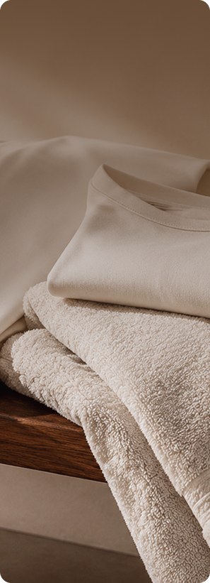 Folded neutral cotton textiles on a wooden surface